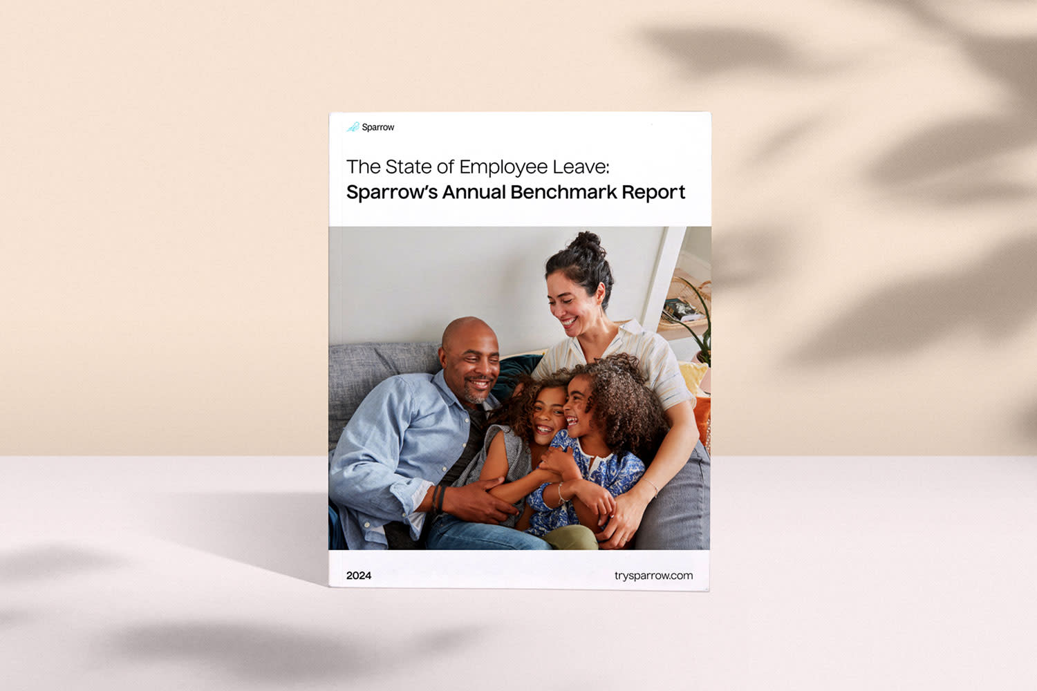 A report titled "The State of Employee Leave: Sparrow's Annual Benchmark Report" for 2024. The cover image shows a smiling family of four, with parents sitting on a couch and their two children embracing them. The report delves into hybrid workforce benefits and paid leave expansion.