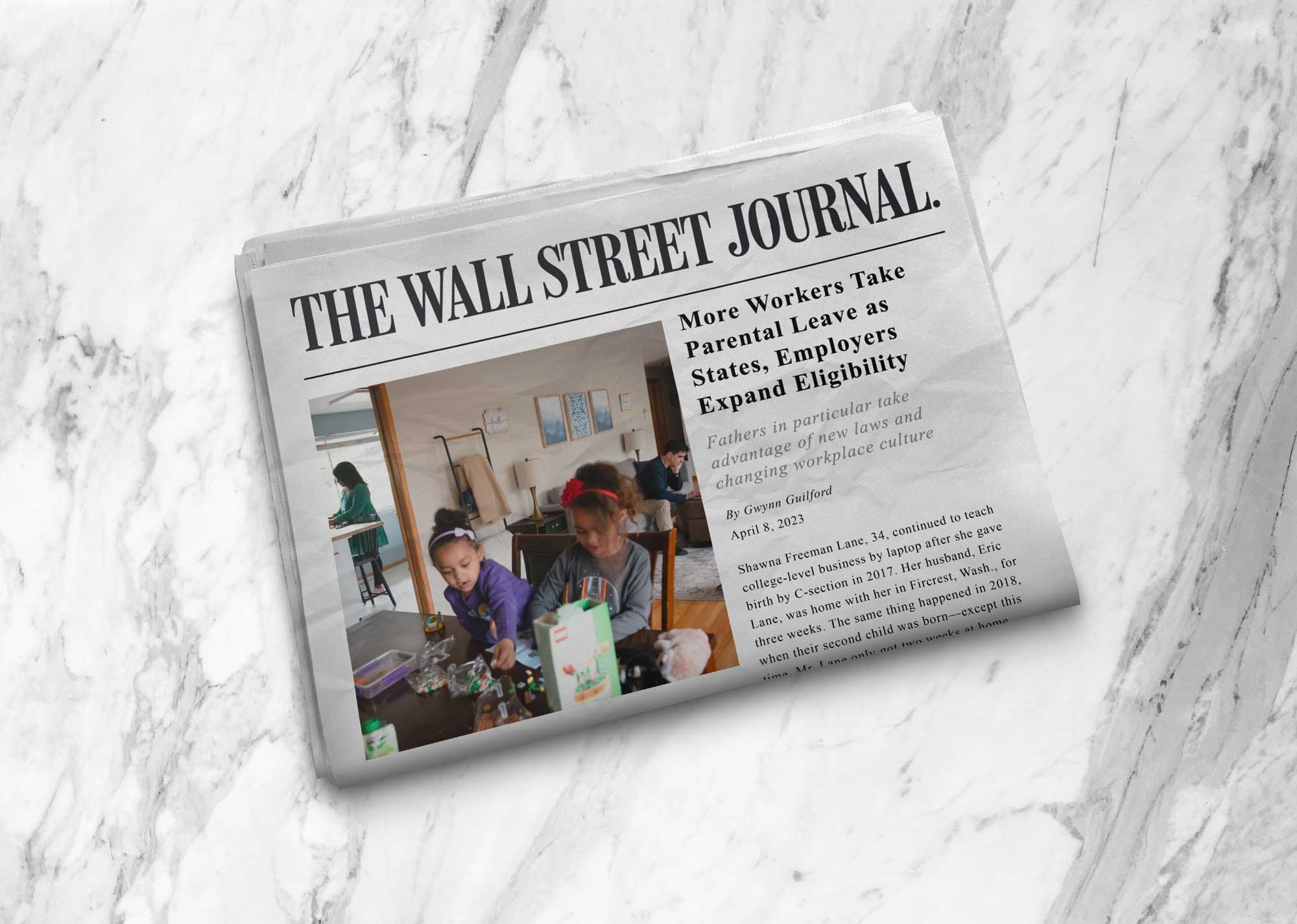 A newspaper titled "The Wall Street Journal" rests on a marble surface. The headline reads "More Workers Take Parental Leave as States, Employers Expand Eligibility," accompanied by an image of a father and two young children working on a craft project at a table, highlighting evolving leave policies.